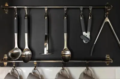 a rack with utensils hanging on a wall at One of Kind Boutique Pad in Liverpool