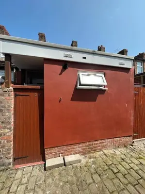 a red building with a window on the side of it at Charming newly renovated terrace in Liverpool