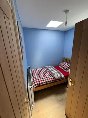 a room with a bed in a blue room at Charming newly renovated terrace in Liverpool
