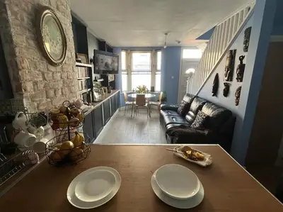 a living room with a table with two plates on it at Charming newly renovated terrace in Liverpool