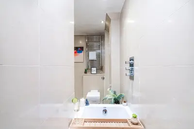a white bathroom with a tub and a sink at Cavern Quarters, Beautiful Two Bedroom City Centre Apartment by Garudy Serviced Apartments in Liverpool