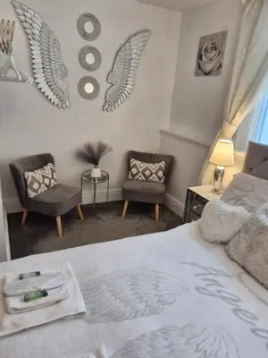 a bedroom with a bed with wings on the wall at Rocklea Hotel in Blackpool