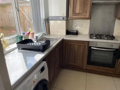 a kitchen with a sink and a stove top oven at Marks Place in Liverpool