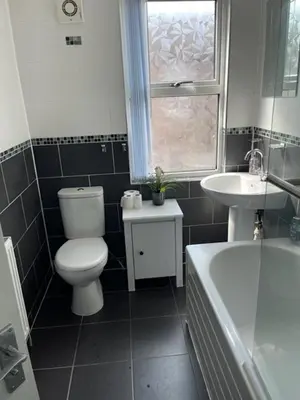 a bathroom with a toilet and a sink and a tub at Marks Place in Liverpool