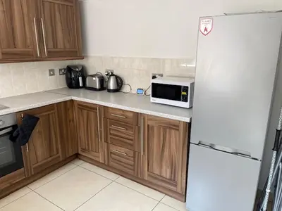 a kitchen with a white refrigerator and a microwave at Marks Place in Liverpool