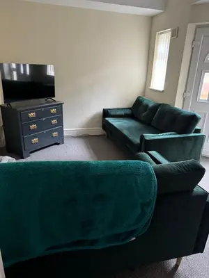 a living room with a couch and a tv at Marks Place in Liverpool