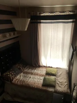a bed in a room with a window at Ardern Hotel in Blackpool