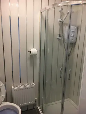 a bathroom with a shower and a toilet at Ardern Hotel in Blackpool