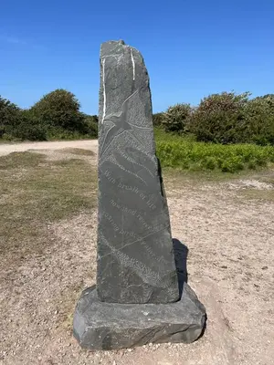 a stone pillar sitting on top of a field at Lake View 92 in Millom