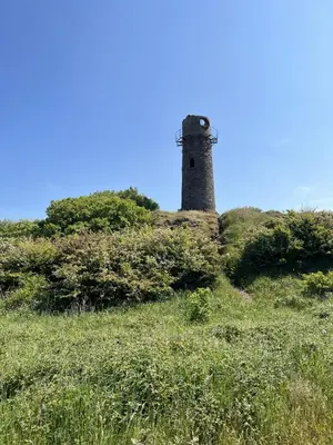 a lighthouse sitting on top of a hill at Lake View 92 in Millom