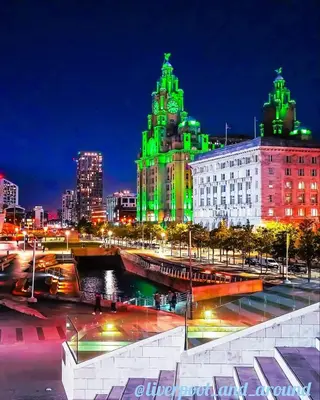 a city at night with green lights on buildings at Crabtree House in Moreton