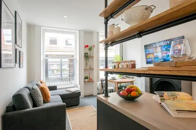 a living room with a couch and a fireplace at Preston Apartments in Preston
