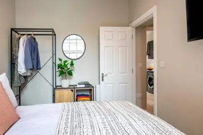 a bedroom with a bed and a closet at Preston Apartments in Preston