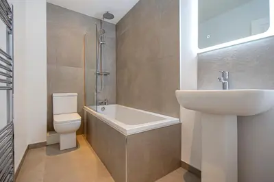 a bathroom with a sink and a tub and a toilet at Preston Apartments in Preston