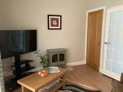 a living room with a fireplace and a television at Fairways in Cleveleys