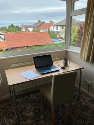 a laptop computer sitting on a desk in front of a window at Fairways in Cleveleys