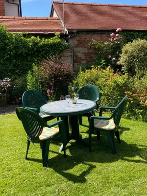 a table and four chairs in a yard at Fairways in Cleveleys