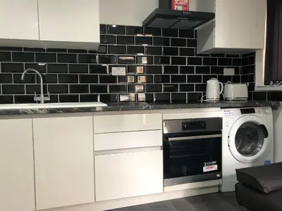 a kitchen with a washer and a dishwasher at Ground Floor Apartment 2, Lynton Apartments in Blackpool