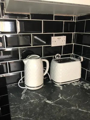 a toaster and a toaster on a kitchen counter at Ground Floor Apartment 2, Lynton Apartments in Blackpool