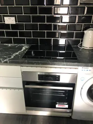 a kitchen with a stove and a dishwasher at Ground Floor Apartment 2, Lynton Apartments in Blackpool