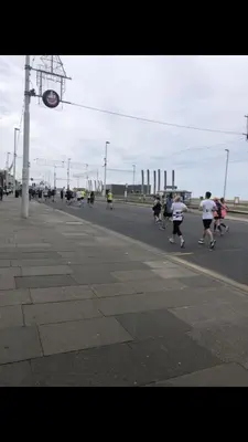 a group of people running down a street at Ground Floor Apartment 2, Lynton Apartments in Blackpool