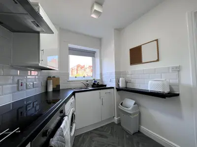 a white kitchen with a washing machine in it at Marina Princes Reach 2 in Penwortham