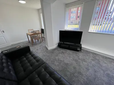 a living room with a couch and a flat screen tv at Marina Princes Reach 2 in Penwortham