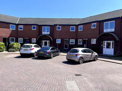 three cars parked in a parking lot in front of a brick building at Marina Princes Reach 2 in Penwortham