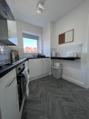 a white kitchen with a sink and a toilet at Marina Princes Reach 2 in Penwortham