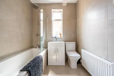 a bathroom with a toilet and a sink and a window at Luxury Liverpool Accommodation in Liverpool