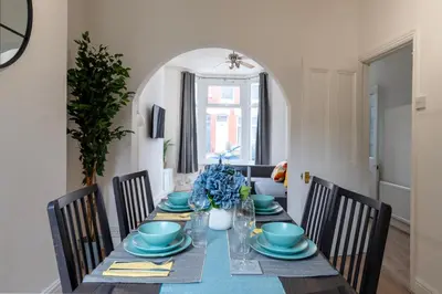 a dining room with a table with blue dishes at Luxury Liverpool Accommodation in Liverpool