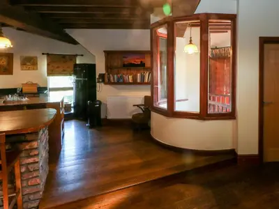 a living room with a bar and a kitchen at Windmill On The Farm in Ormskirk