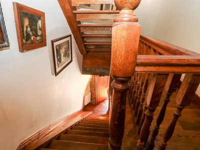 a wooden staircase in a house with wooden floors at Windmill On The Farm in Ormskirk