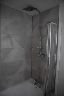 a shower with a glass door in a bathroom at Woodland House - in Walton le Dale