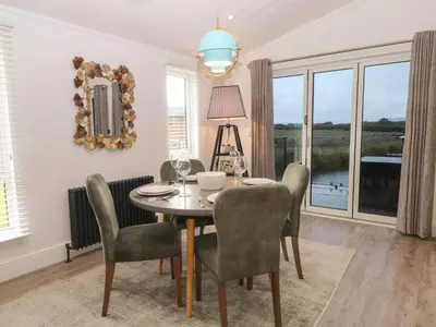 a dining room with a table and chairs and a window at Ruperts Retreat in Preston