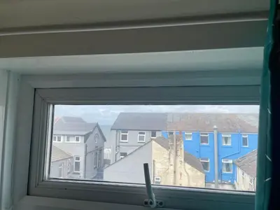 a window with a view of houses and buildings at Jewel Of The Sea Hotel in Blackpool