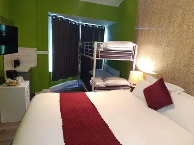 a bedroom with a bed and a bunk bed at Jewel Of The Sea Hotel in Blackpool