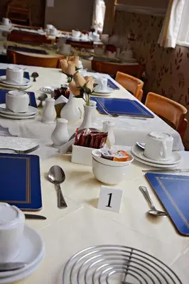 a long table with blue and white dishes on it at Tobermory Hotel in Blackpool