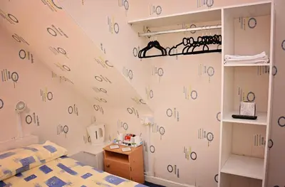 a room with a bed and a wall with numbers on it at Tobermory Hotel in Blackpool