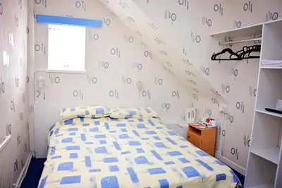 a bedroom with a bed with a wall with numbers on it at Tobermory Hotel in Blackpool