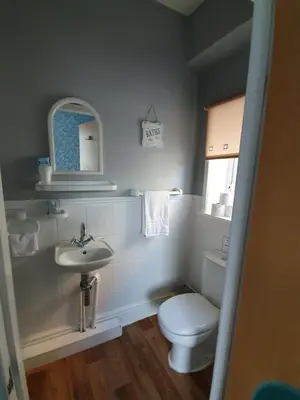 a small bathroom with a toilet and a sink at Tobermory Hotel in Blackpool