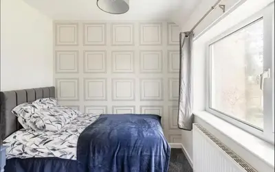 a bedroom with a bed with blue sheets and a window at Lookout 5-Bed House in Darwen Blackburn BB1 Free Parking Roadside in Rishton