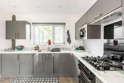 a kitchen with stainless steel cabinets and a stove at Lookout 5-Bed House in Darwen Blackburn BB1 Free Parking Roadside in Rishton
