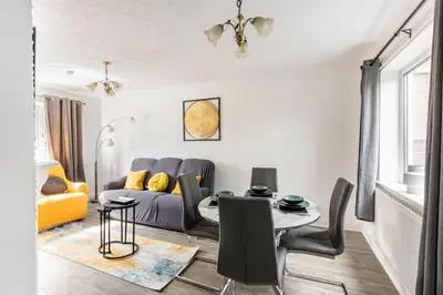 a living room with a table and a couch at Lookout 5-Bed House in Darwen Blackburn BB1 Free Parking Roadside in Rishton