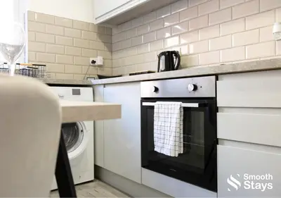 a kitchen with a stove and a dishwasher at One Bedroom Apartment At Smooth Stays Short Lets & Serviced Accommodation Preston With Parking Near Train Station in Preston
