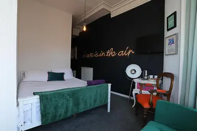 a bedroom with a bed and a desk with a table sidx sidx sidx at Ferny House in Blackpool