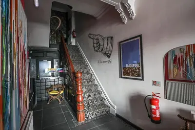 a hallway with a spiral staircase in a house at Ferny House in Blackpool
