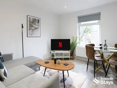 a living room with a couch and a tv and a table at Modern 2 Bed Apartment By Smooth Stays Short Lets & Serviced Accommodation Preston With Parking Near Train Station in Preston