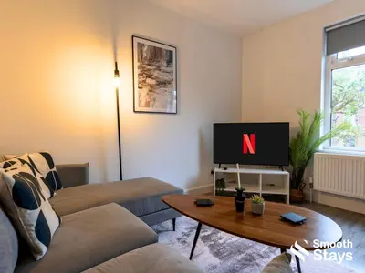 a living room with a couch and a tv at Modern 2 Bed Apartment By Smooth Stays Short Lets & Serviced Accommodation Preston With Parking Near Train Station in Preston