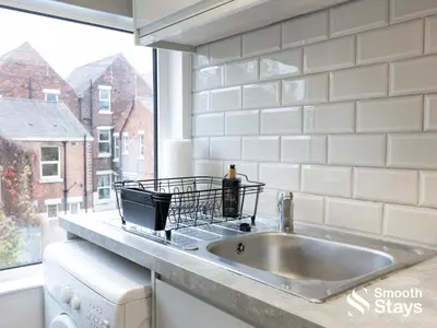 a kitchen counter with a sink and a window at Modern 2 Bed Apartment By Smooth Stays Short Lets & Serviced Accommodation Preston With Parking Near Train Station in Preston